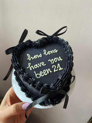 Черна торта сърце с панделки и надпис 'how long have you been 21'