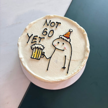A round white cake with an illustration and the inscription 'NOT 60 YET'
