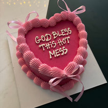 Розова торта сърце с кремав кант, панделки и надпис GOD BLESS THIS HOT MESS